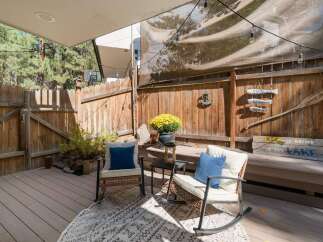 Enjoy outdoor living on this charming deck, perfect for relaxing or entertaining.