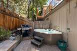 Enjoy outdoor living with this fantastic backyard setup, featuring a spacious hot tub perfect for relaxation and a Weber grill ready for summer barbecues.