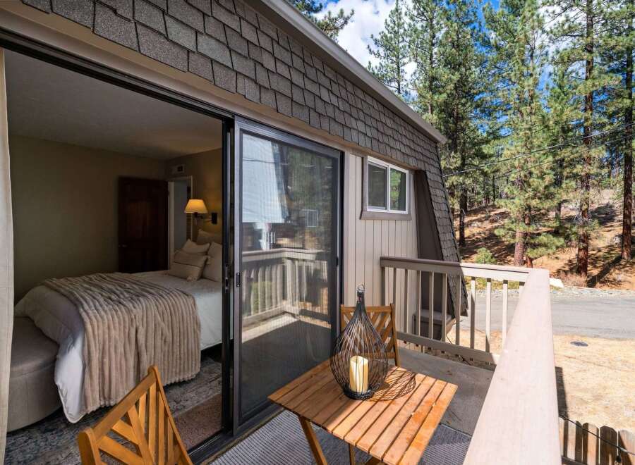 Step outside your cozy bedroom onto a private balcony, perfect for enjoying the serene mountain air.