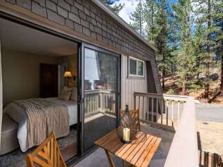 Step outside your cozy bedroom onto a private balcony, perfect for enjoying the serene mountain air.