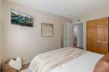This bedroom offers a modern and comfortable retreat, featuring a wall-mounted television for entertainment and a large closet for ample storage.