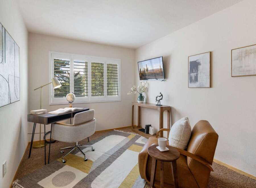 This home office features a modern desk with a globe and a comfortable office chair, perfect for productivity.