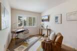 This home office features a modern desk with a globe and a comfortable office chair, perfect for productivity.