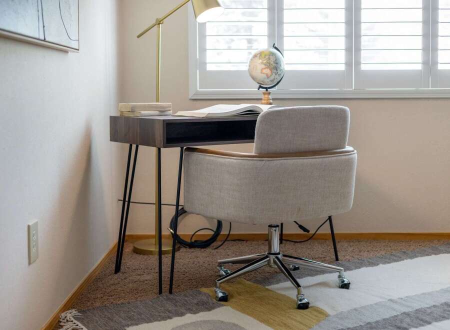 Create a productive and stylish home office with this modern desk and comfortable chair set.