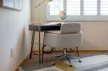 Create a productive and stylish home office with this modern desk and comfortable chair set.