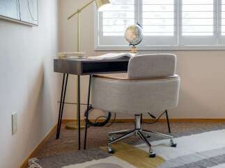 Create a productive and stylish home office with this modern desk and comfortable chair set.