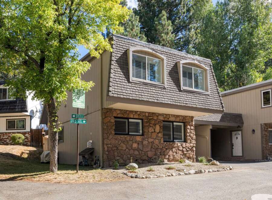 Discover this charming property featuring a unique mansard roof and a rustic stone facade, offering a distinctive architectural appeal.