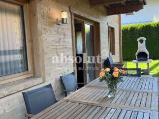 Enjoy outdoor living on this charming wooden deck, complete with a dining table set for al fresco meals and a built-in barbecue for summer cookouts.