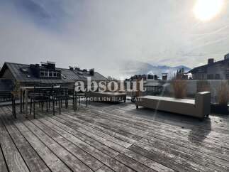Enjoy breathtaking mountain views from this spacious wooden deck, perfect for outdoor entertaining.