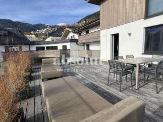 Enjoy breathtaking mountain views from this stunning modern apartment's expansive terrace.