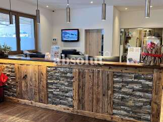 Experience a warm welcome at this charming reception area, featuring a rustic wooden and stone counter.
