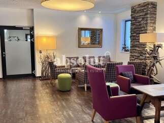 Step into a welcoming lobby area featuring comfortable seating arrangements and unique decorative elements.