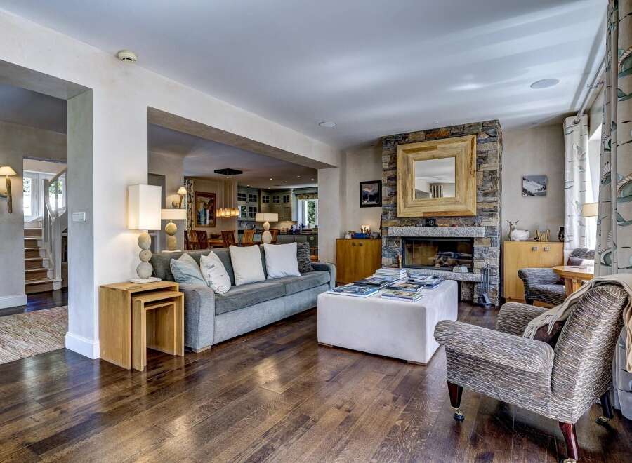 Experience luxurious living in this beautifully appointed living room, featuring a stunning stone fireplace as the focal point.