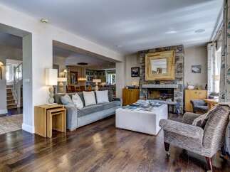 Experience luxurious living in this beautifully appointed living room, featuring a stunning stone fireplace as the focal point.