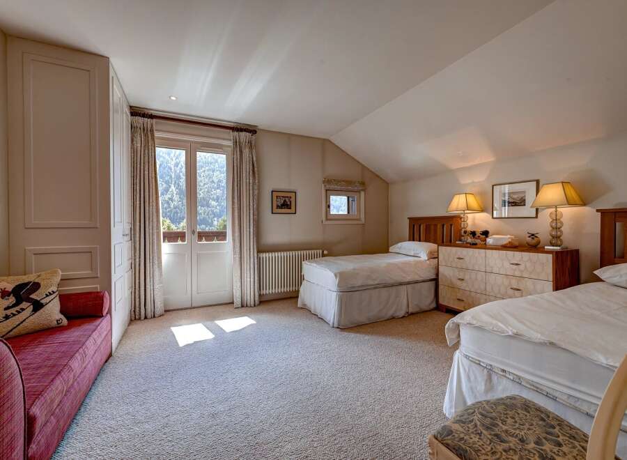 This charming bedroom features two twin beds, perfect for accommodating guests or family.