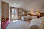 This charming bedroom features two twin beds, perfect for accommodating guests or family.