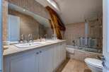 This charming bathroom features a spacious double vanity with modern chrome fixtures and ample counter space, perfect for busy mornings.
