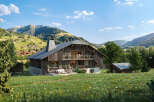 Experience luxurious mountain living in this stunning chalet, nestled amidst rolling green hills and majestic peaks.