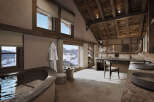 Experience unparalleled luxury in this stunning mountain retreat bathroom, featuring a deep soaking tub with breathtaking snowy landscape views.