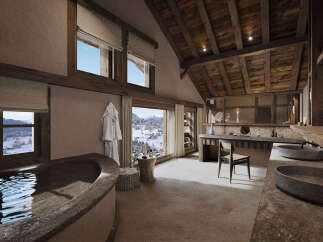 Experience unparalleled luxury in this stunning mountain retreat bathroom, featuring a deep soaking tub with breathtaking snowy landscape views.