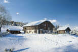 Experience the charm of a winter wonderland with this stunning property nestled in a snowy landscape.