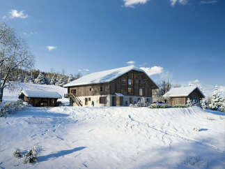 Experience the charm of a winter wonderland with this stunning property nestled in a snowy landscape.