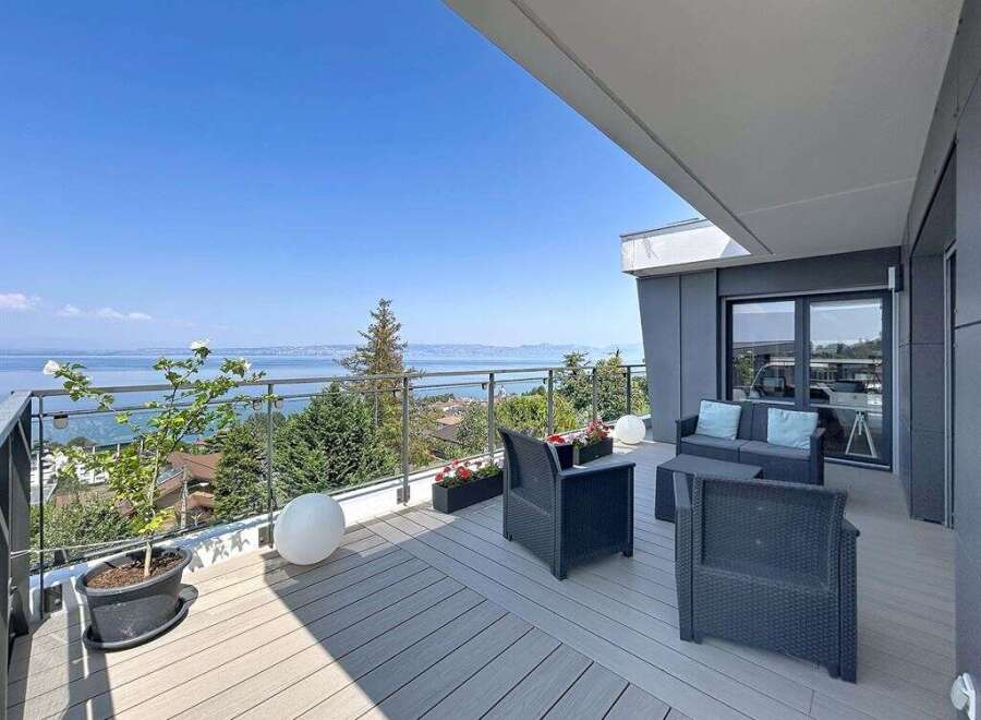 Enjoy breathtaking lake and mountain views from this stunning modern balcony.