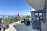 Enjoy breathtaking lake and mountain views from this stunning modern balcony.