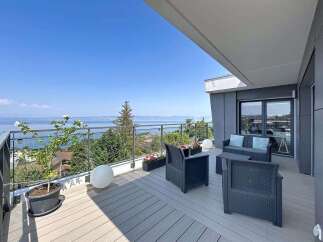 Enjoy breathtaking lake and mountain views from this stunning modern balcony.