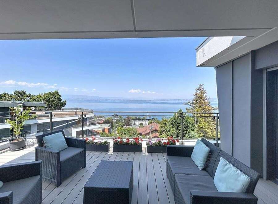 Enjoy breathtaking lake and mountain views from this stunning modern balcony.