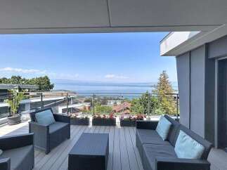 Enjoy breathtaking lake and mountain views from this stunning modern balcony.