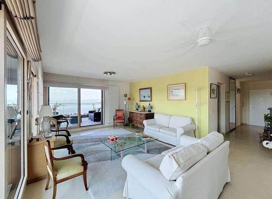Experience breathtaking ocean views from this stunning living room, featuring a spacious layout perfect for relaxation and entertaining.