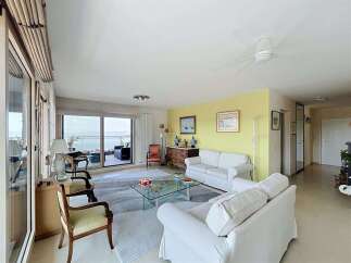 Experience breathtaking ocean views from this stunning living room, featuring a spacious layout perfect for relaxation and entertaining.