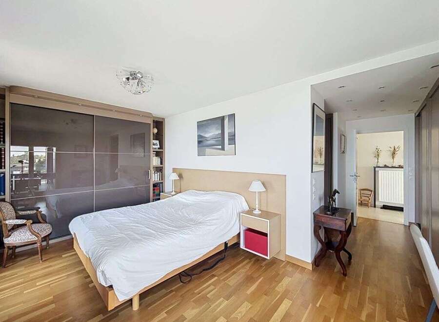 This spacious bedroom features a large sliding door wardrobe, perfect for ample storage.