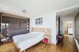 This spacious bedroom features a large sliding door wardrobe, perfect for ample storage.