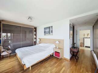 This spacious bedroom features a large sliding door wardrobe, perfect for ample storage.