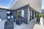 Enjoy breathtaking views from this modern apartment's spacious balcony, perfect for outdoor entertaining.