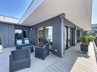Enjoy breathtaking views from this modern apartment's spacious balcony, perfect for outdoor entertaining.