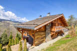 Experience the charm of this rustic wooden chalet nestled amidst breathtaking mountain scenery.