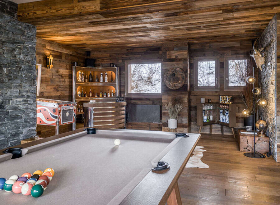 Experience ultimate relaxation and entertainment in this stunning mountain lodge game room.