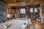 Experience ultimate relaxation and entertainment in this stunning mountain lodge game room.