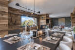 Experience luxurious mountain living in this stunning dining area, featuring a large wooden table set for a formal meal.