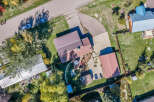 Discover this charming property featuring multiple buildings with distinct roofing, including a prominent blue metal roof and several brown metal roofs.