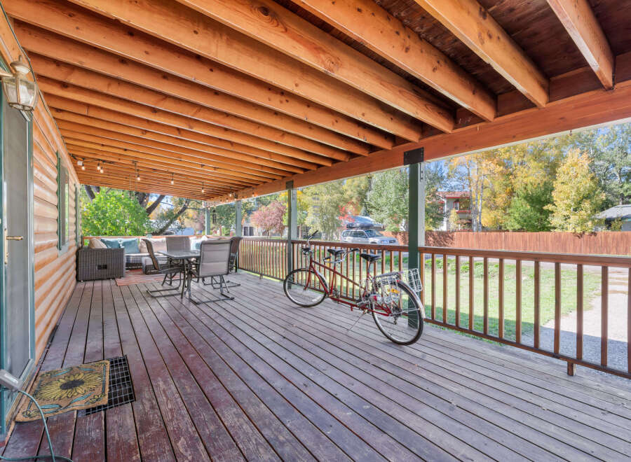 Enjoy the outdoors on this spacious covered deck, perfect for relaxing or entertaining.
