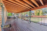 Enjoy the outdoors on this spacious covered deck, perfect for relaxing or entertaining.