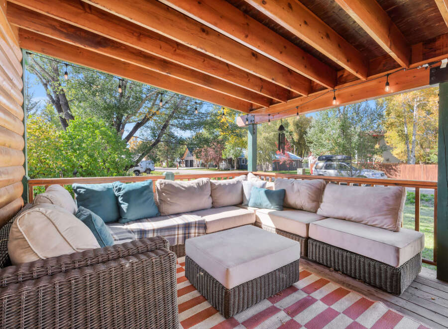 Enjoy the crisp autumn air on this spacious covered porch, perfect for relaxing or entertaining.
