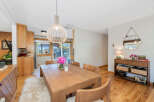 This dining area features a warm and inviting atmosphere with its natural wood elements and soft lighting.