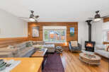 Cozy up by the fire in this inviting living room, featuring a sectional sofa and a stylish armchair.