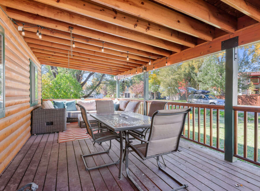Enjoy outdoor living on this spacious covered porch, perfect for entertaining or relaxing.