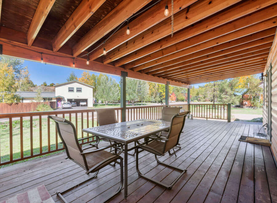 Enjoy outdoor living on this spacious covered deck, perfect for entertaining or relaxing.